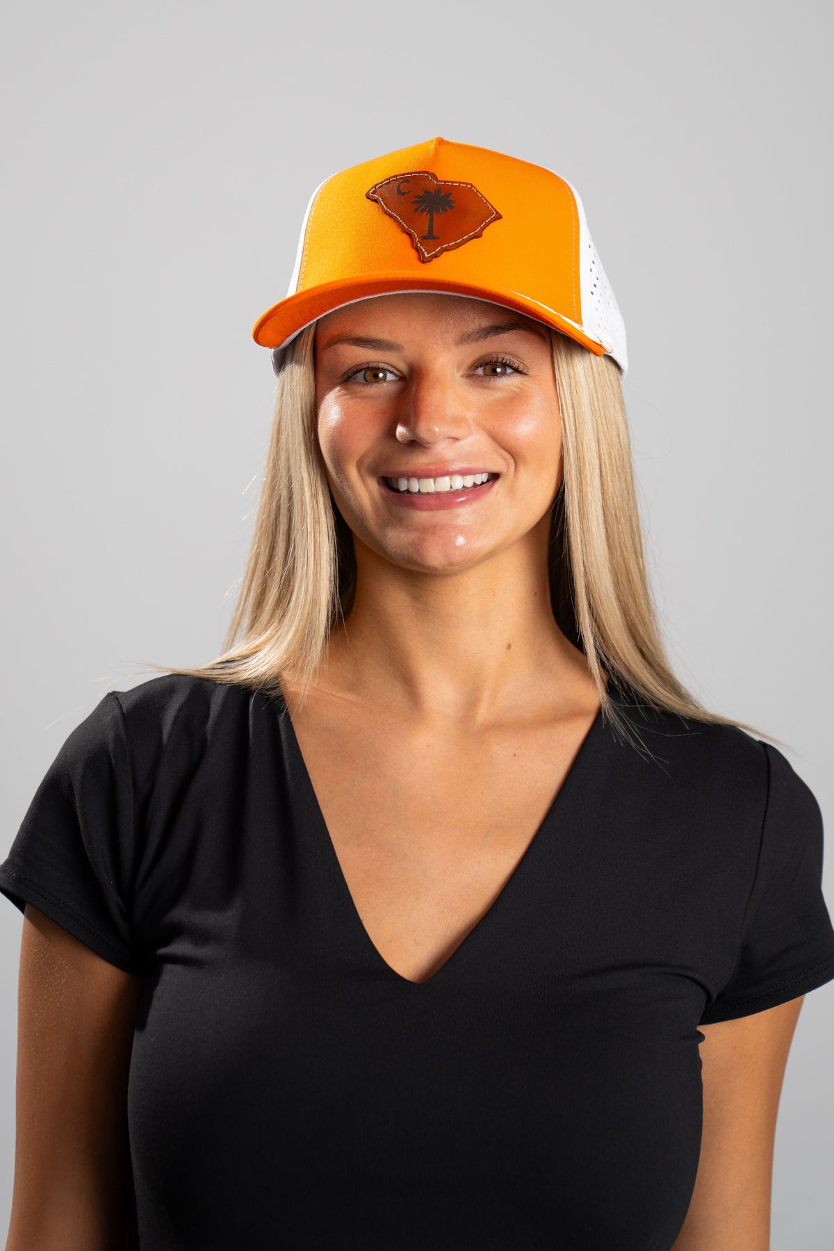 Orange and white HatFlow performance hat with leather Palmetto patch
